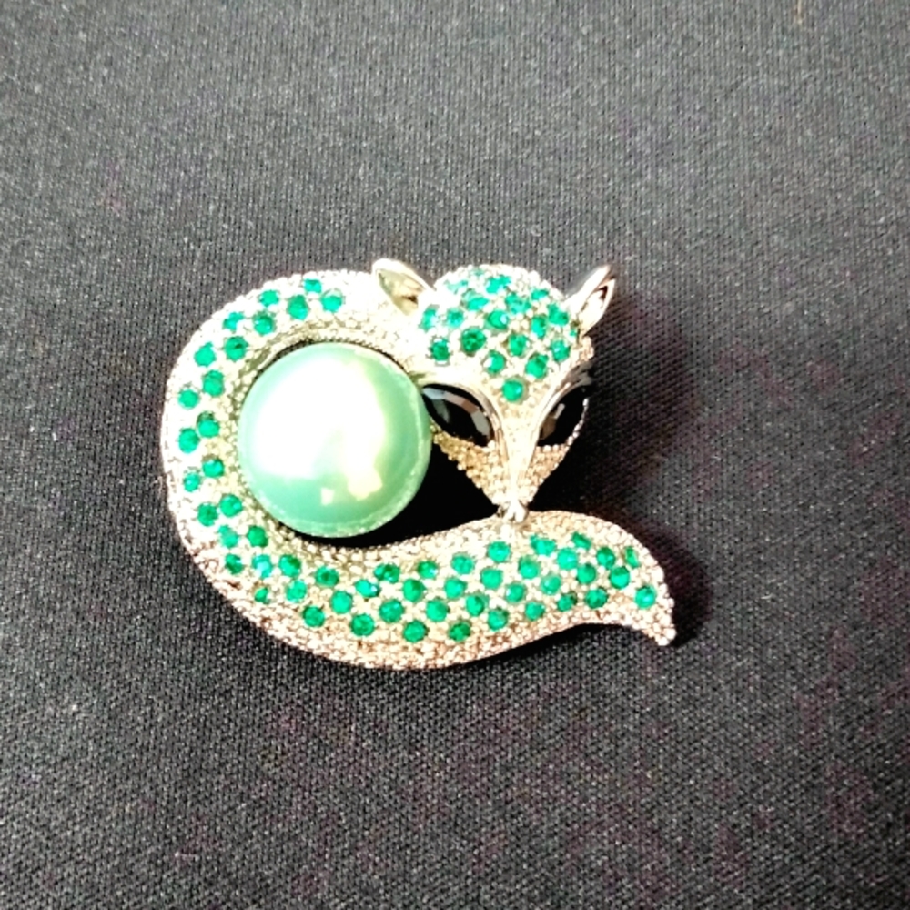 Fox brooch with green and white rhinestones.